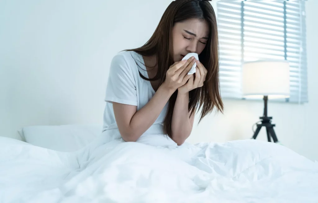 asian girl in pajamas sick due allergies