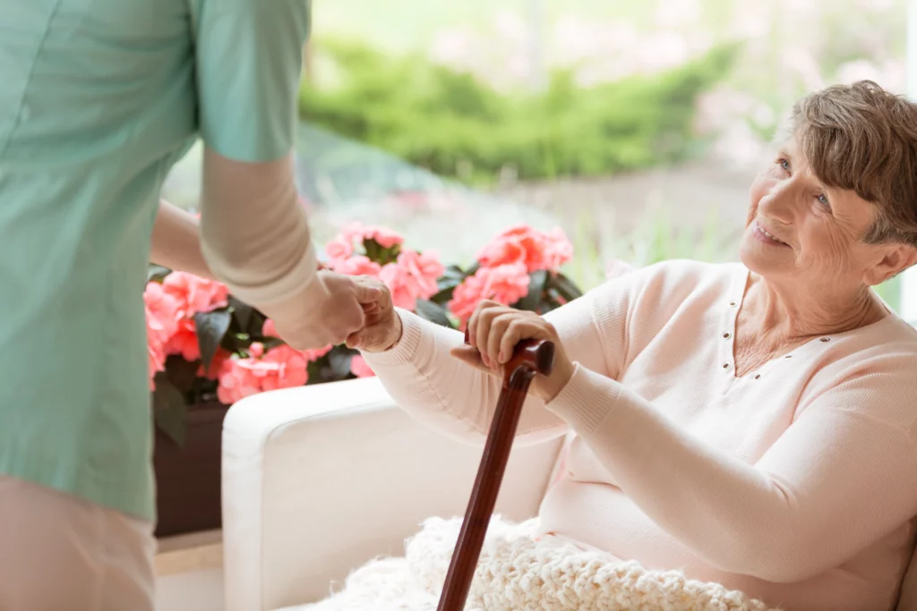 doctor helping an elderly woman with parkinson